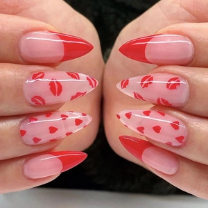Long pointed red French press-on nails with red heart and lip prints for Valentine's Day