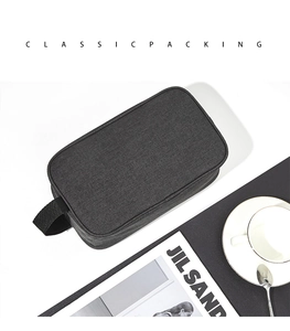 Close-up of waterproof Oxford cloth toiletry bag with handle on a minimalist desk