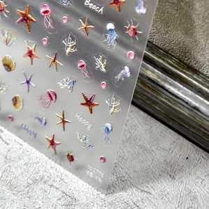 Detailed 3D embossed ocean nail stickers featuring sea stars and coral on transparent sheet