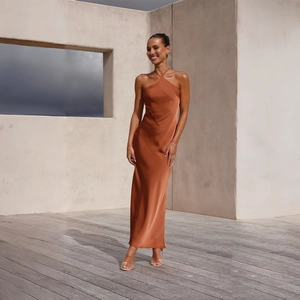 Detail of elegant orange-brown halter satin dress showing silky fabric and texture