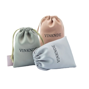 Three premium microfiber drawstring jewelry pouches in sage green, nude pink, and light blue