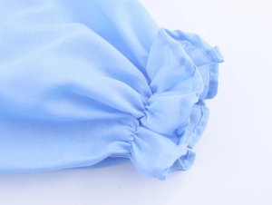Detailed close-up of light blue elastic ruffled cuffs on a cotton linen summer dress