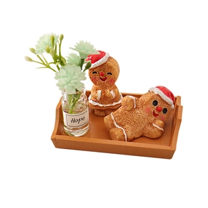 Miniature Christmas gingerbread man set with wooden tray and green plant in Hope glass bottle