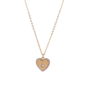 Detailed macro view of a gold heart pendant necklace with shimmering zircon stones