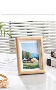 Detail of minimalist wooden frame with high-transparency plexiglass showing natural scenery