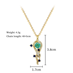 Macro shot of gold snake necklace with green gemstone, 4.5g weight and 40+5cm length specs