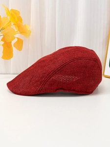 Side view detail of a breathable dark red linen flat cap with textured woven fabric