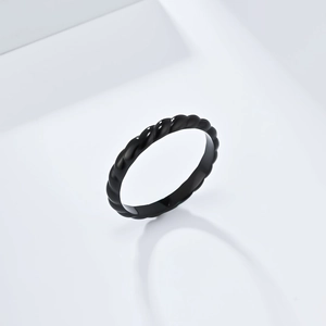 Detail of minimalist black twisted rope ring with a glossy finish and thin band design