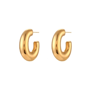 Macro detail of chunky C-shaped hoop earrings with 18K gold-plated polished finish