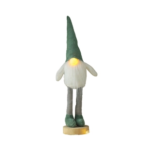 Illuminated Christmas gnome doll with green knitted hat and wooden base for desk decoration