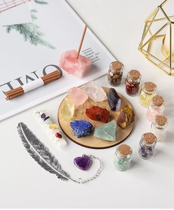 Macro detail of a crystal healing set with gemstones, drift bottles and wooden energy disk