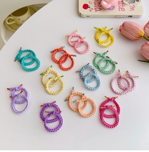 Detail of colorful braided high elastic hair ties in candy colors for girls ponytails