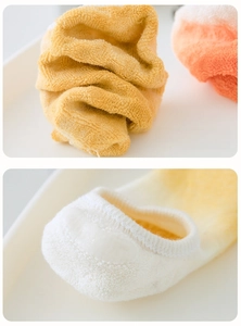 Close-up of non-slip silicone heel strips and cushioned cotton towel fabric on yoga socks