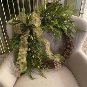 Pastoral style artificial green plant wreath with poppy berries on grapevine base