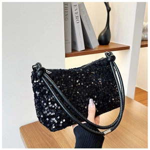 Detailed macro of black sequin handbag with luxury shine and knotted leather strap