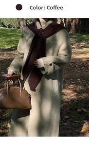 Outdoor shot of a casual coffee knit scarf shawl paired with a beige wool coat