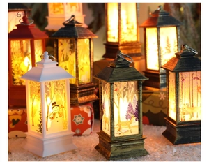 Close-up of LED Christmas lanterns with snowman and reindeer cutouts for table decor