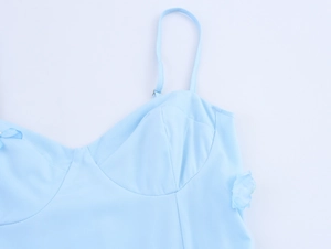 Detail of light blue dress showing 3D floral accent and fine fabric texture