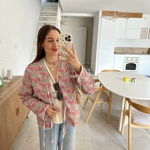 Pink floral quilted jacket with V-neck tie closure for women shown in mirror selfie