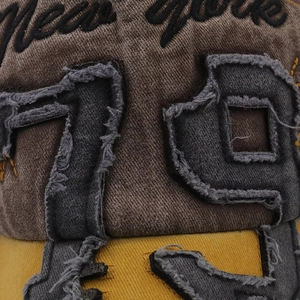 Close-up of vintage New York 79 embroidery and washed cotton twill fabric on baseball cap