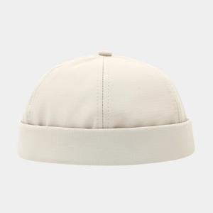 Detail of beige quick-dry docker cap featuring six-panel crown and rolled cuff texture