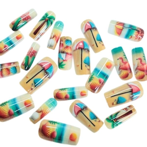 Summer beach press-on nails featuring palm trees, seashells and flamingo vacation designs