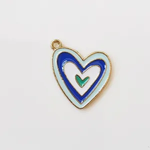 Macro detail of multi-layer colorful enamel heart pendant with golden alloy rim