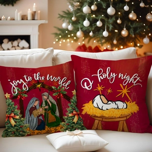Detail of red Christmas pillows with Joy to the World print near a festive fireplace
