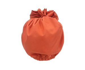 Detail of orange floral turban hat with elastic band and soft fabric texture