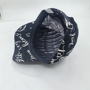 Black polyester baseball cap with white graffiti lettering and adjustable metal buckle
