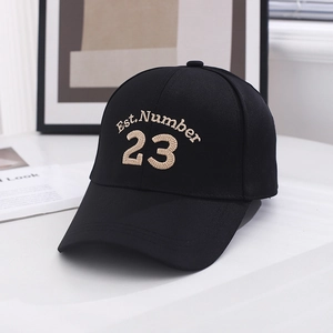 Close-up of black baseball cap featuring beige Est. Number 23 3D embroidery detail