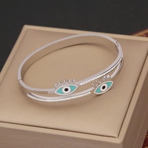 Silver stainless steel evil eye bangle featuring turquoise enamel and sparkling crystals