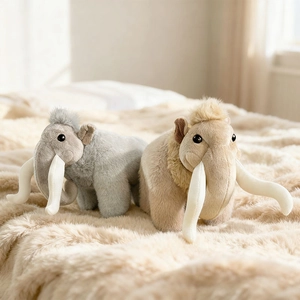Cartoon mammoth plush toy in grey and beige displayed on a soft warm plush rug