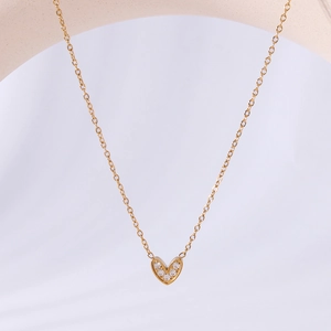 Elegant gold-plated hollow heart pendant necklace with shimmering cubic zirconia stones