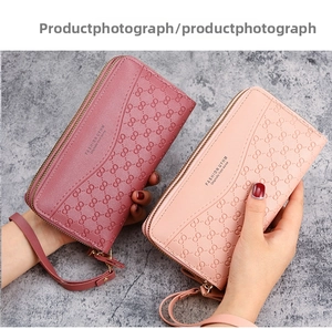 Detail of embossed floral texture and gold zipper on long zip-around women's wallets