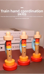 Detailed view of three-hole wooden baby trumpet toys in bright primary colors