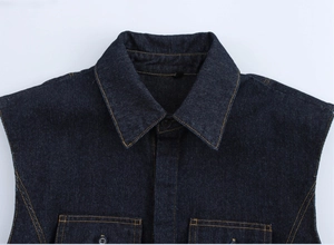 Detail of dark blue denim vest with contrast yellow stitching and pointed collar