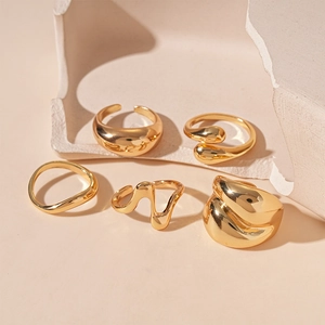 Five-piece minimalist irregular geometric gold rings set with a polished metallic finish
