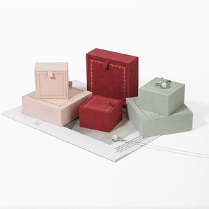 Elegant jewelry gift boxes with gold trim in pink, burgundy, and green velvet finish