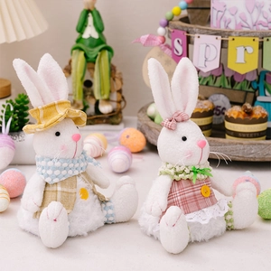 Detail of plush Easter bunnies in pink and yellow plaid outfits with festive decorations