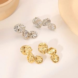 Textured gold and silver fold-style metal stud earrings in irregular round leaf design