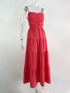 Detailed close-up of the pleated bust and tiered layers of this red maxi dress