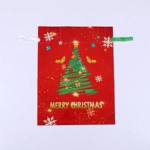 Detail of red Christmas drawstring gift bag with tree pattern and foil finish