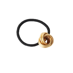 Minimalist black elastic hair tie with gold metallic multi-ring knot decorative accent