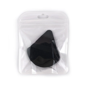 Detail of soft black triangular powder puff in clear protective hanging packaging
