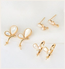 Detailed view of champagne gold butterfly earring hooks with mother of pearl inlay