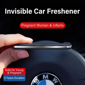 Slim black car air vent solid perfume stick held by hand in a minimalist interior