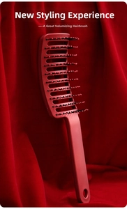 Detail of red vented hairbrush with massage ball-tip bristles on a luxury velvet background