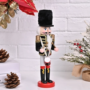 Detailed close-up of a 30cm wooden nutcracker drummer soldier with gold tassels