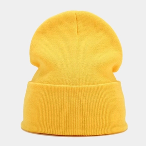 Close-up of bright yellow beanie showing fine vertical knit texture and cuffed design